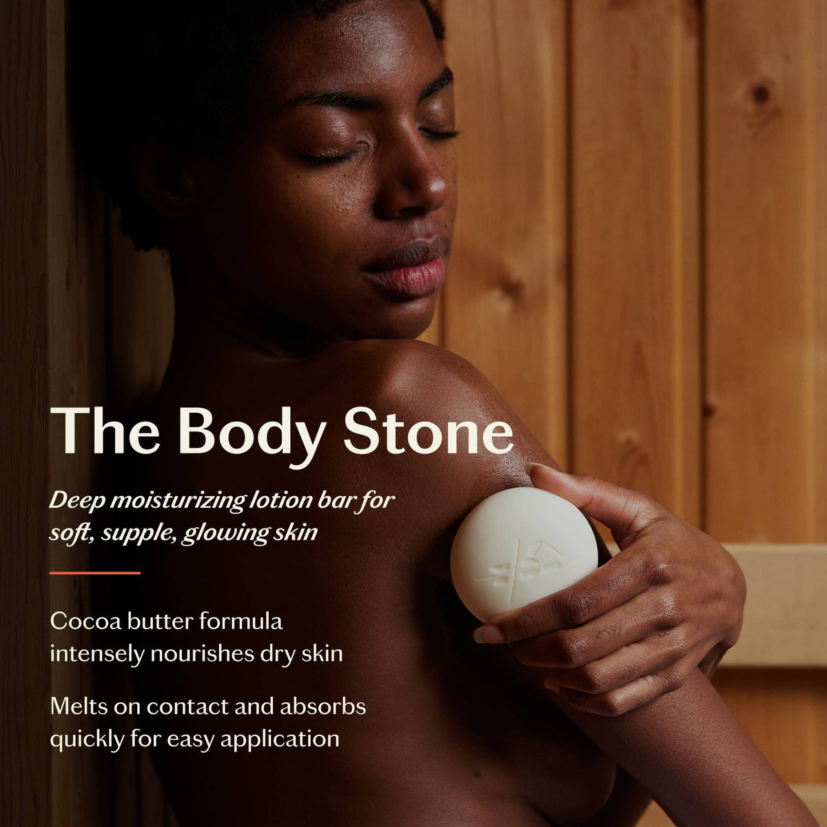 Person holding a white lotion bar with text about 'The Body Stone' product.