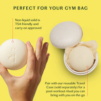 Bar of soap held by a hand with text about TSA and carry-on approval on a yellow background