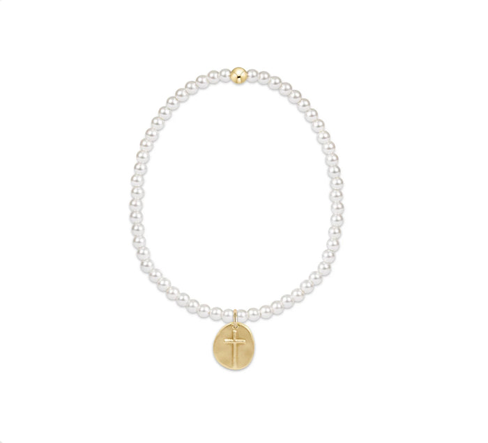 Pearl bracelet on white background with cross charm
