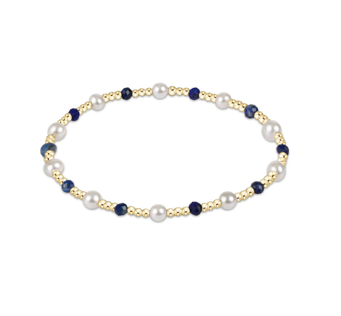 Pearl and blue bead necklace on a white background