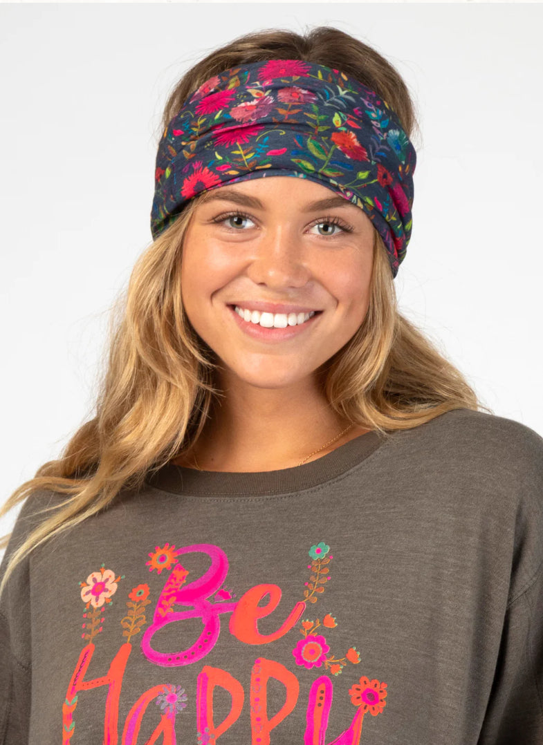 Woman wearing a colorful headband and 'Be Happy' t-shirt on a white background