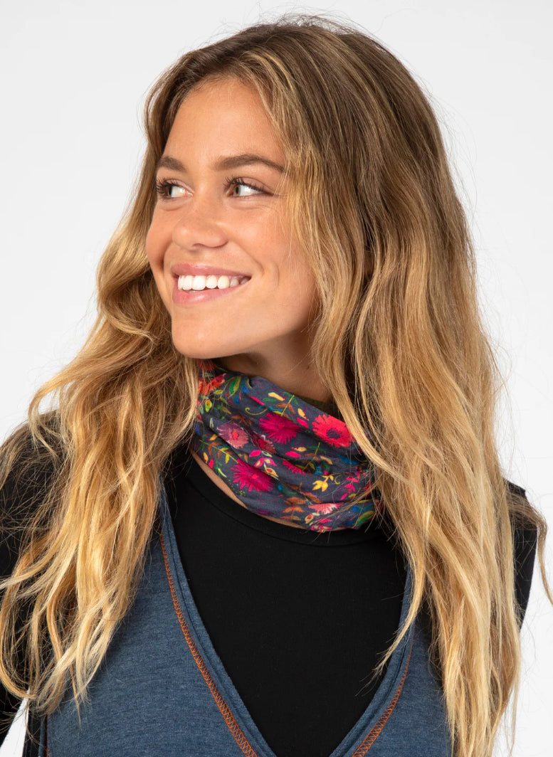 Woman wearing a colorful floral scarf on a white background